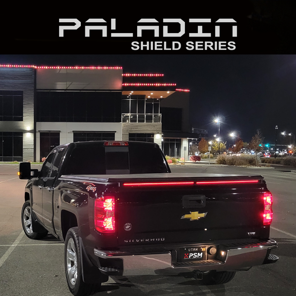 Chevy Silverado 2014–2018 at night with PSM PALADIN LED tailgate protector from the SHEILD series.