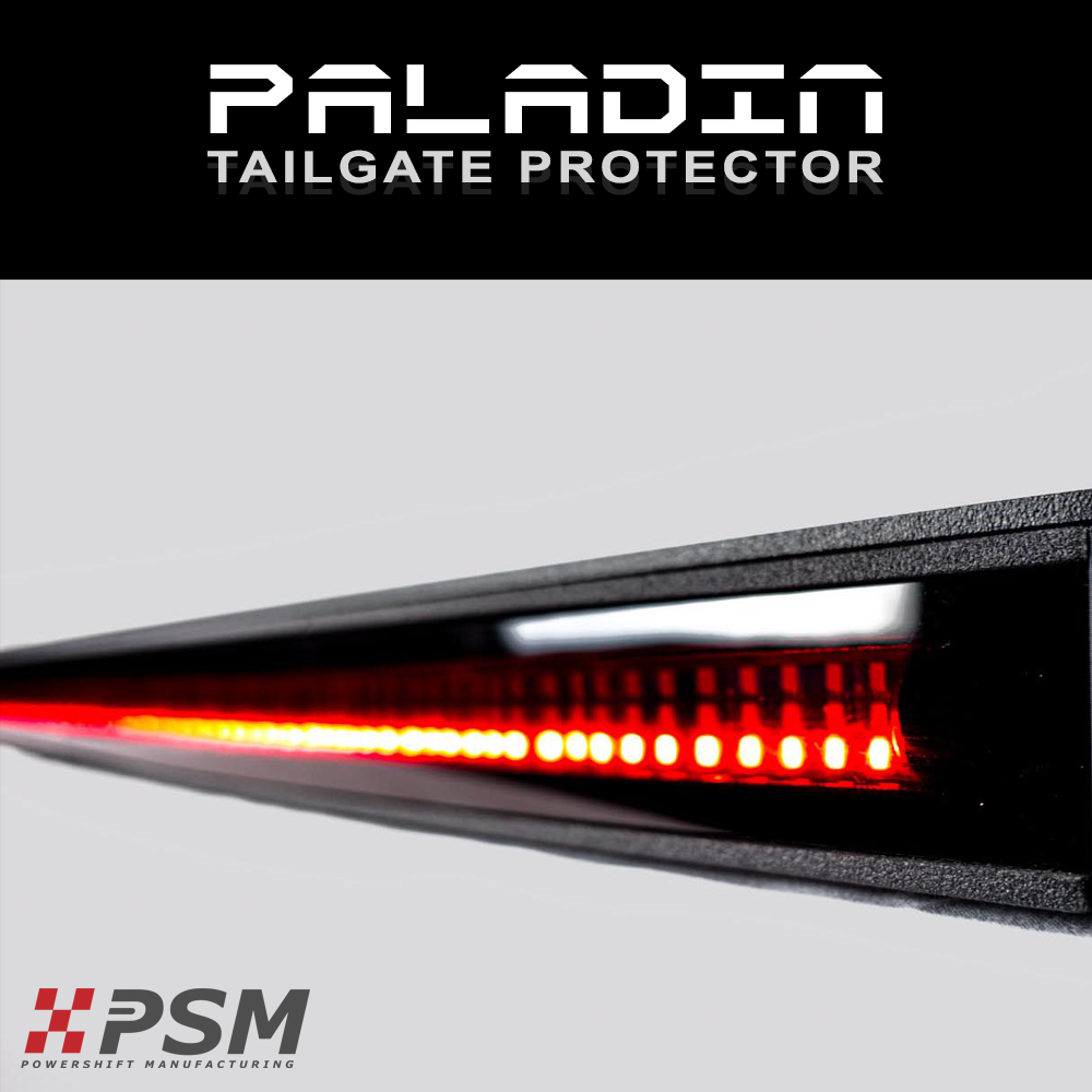 Close up PSM PALADIN LED tailgate protector on a truck bright red high intensity LED's activated
