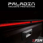 Close up PSM PALADIN LED tailgate protector on a truck tailgate in a studio with bright red high intensity LED's activated